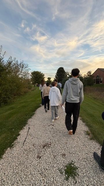 The youth group walking a gravel path during the Rosary Walk.